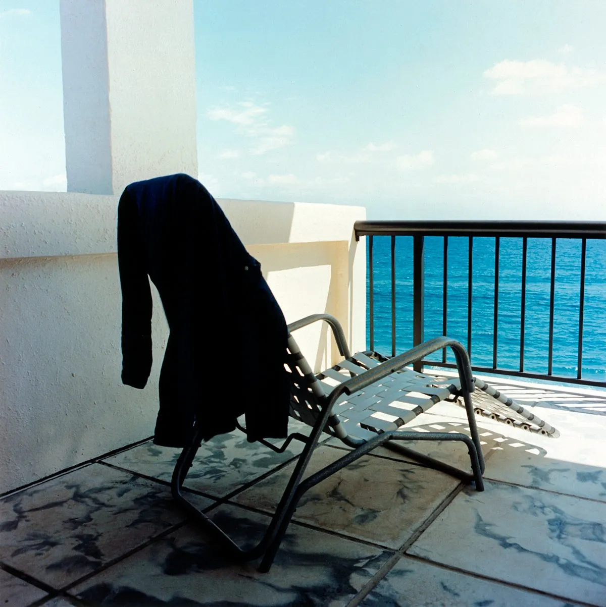 Ocean, Chairs, and Shirt - a photograph by Willard Traub.